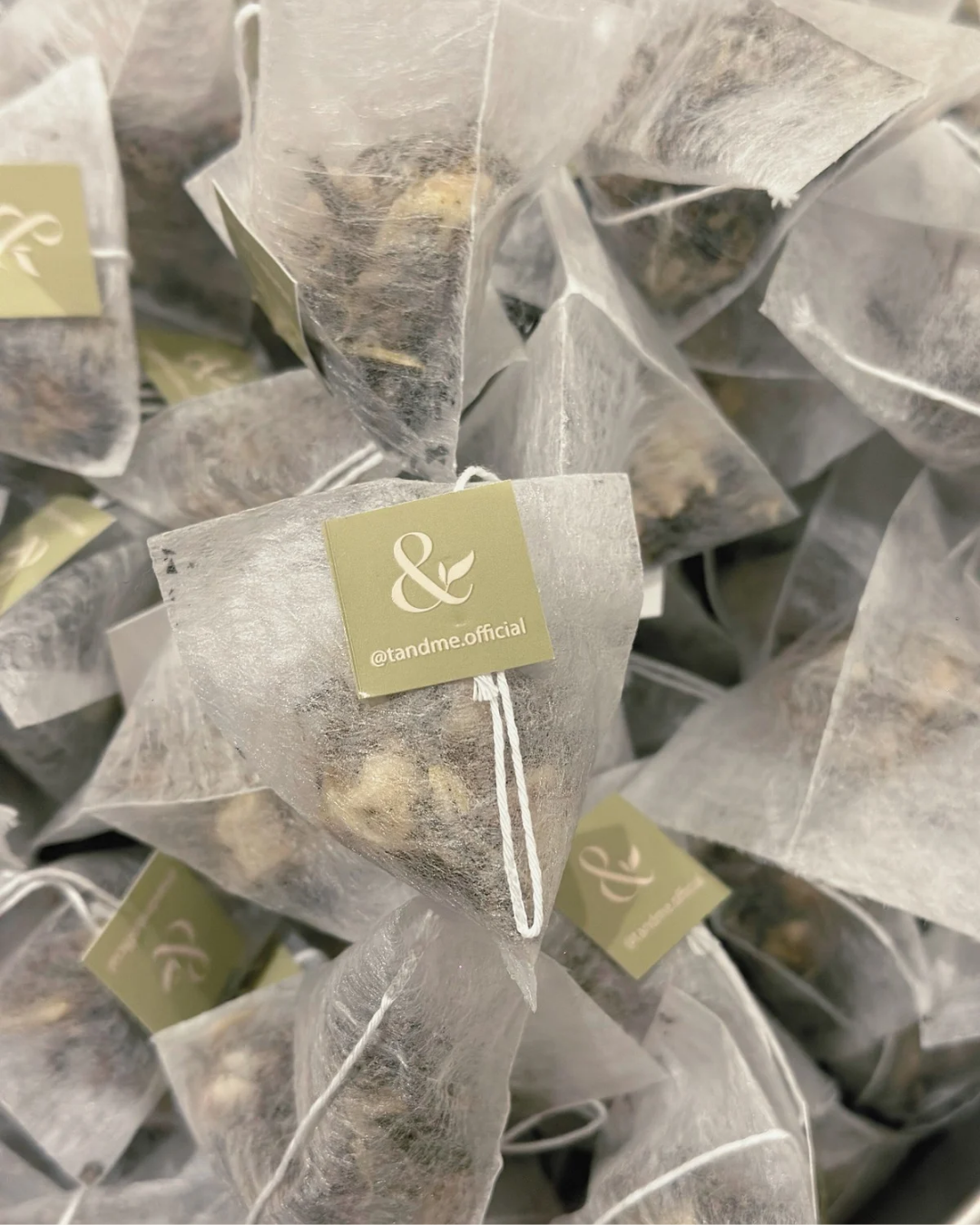 Tea bags with visible brand tag in a pile